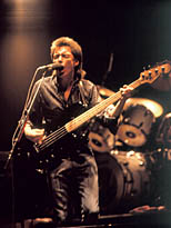 thumbnail link to photograph Bruce Foxton playing bass and singing on stage