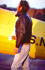 thumbnail link to photograph of Steve at dawn by plane wearing flying jacket